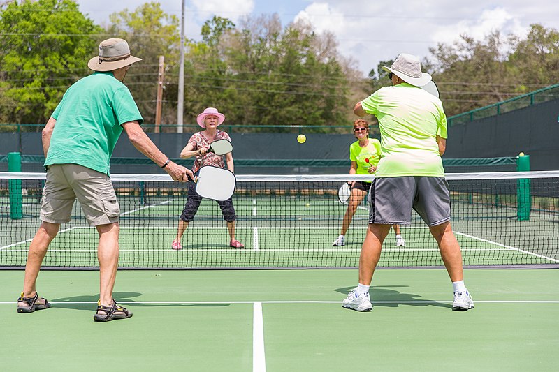 Retirement age baby boomers playing pickleball